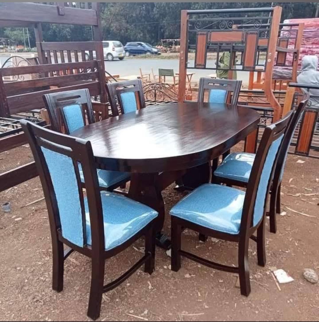 Oval mahogany dining table with six blue upholstered chairs