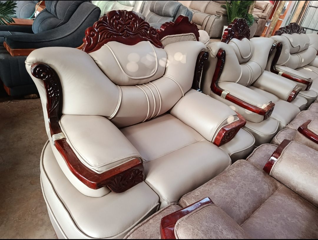 Cream leather royal sofa set with carved mahogany arms at Homewood Furnitures