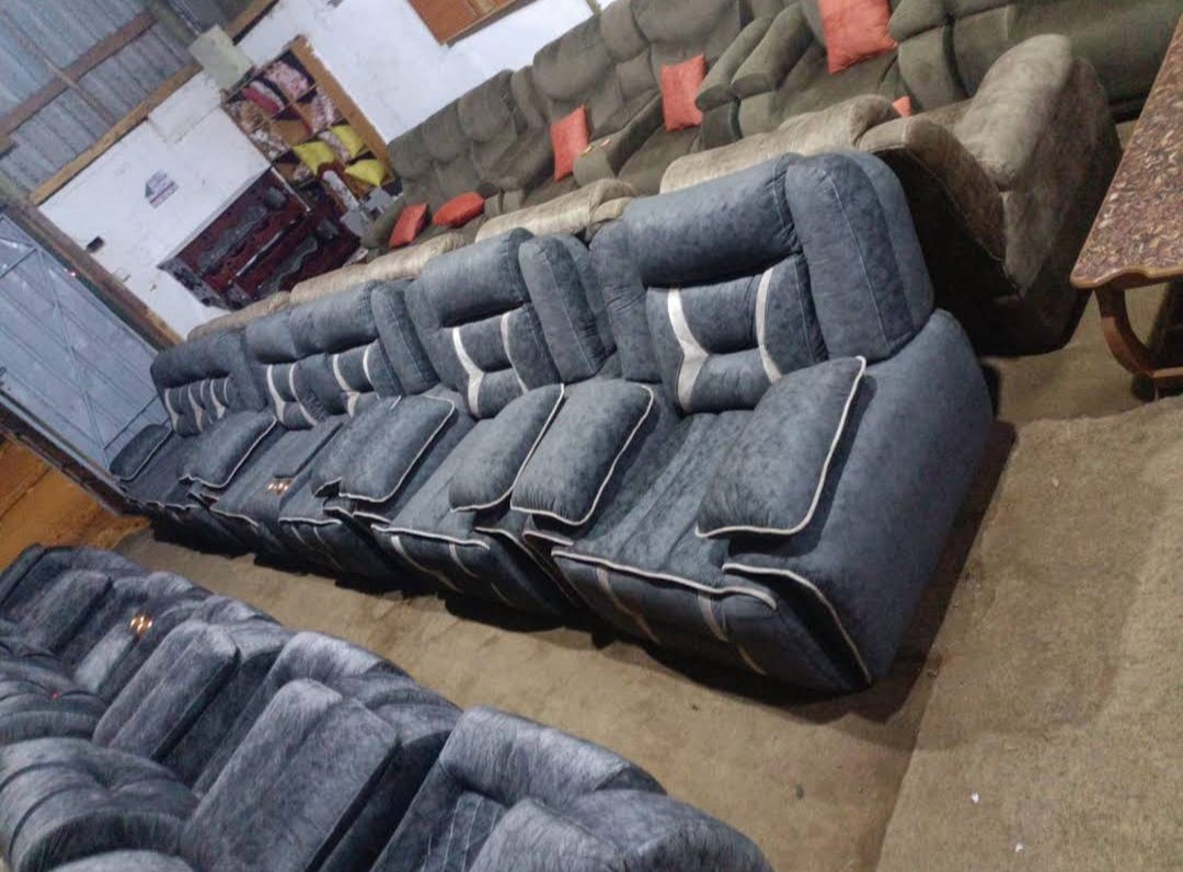 Grey patterned fabric recliner sofa set on the showroom floor