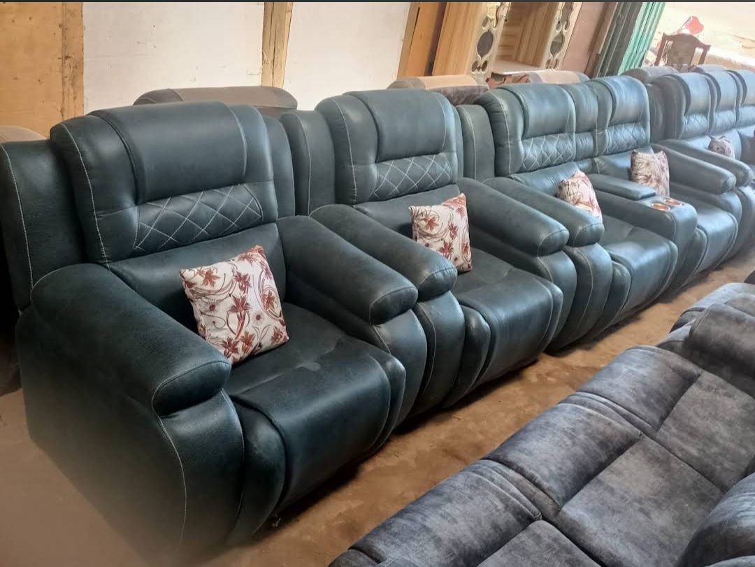Teal leather recliner sofa set with cup-holder consoles and matching pillows